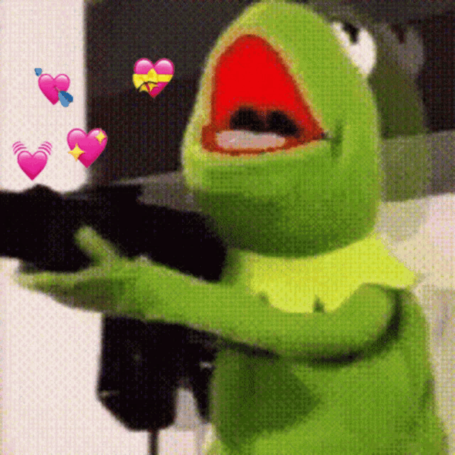 kermit the frog is holding a gun with his mouth open and hearts flying around him