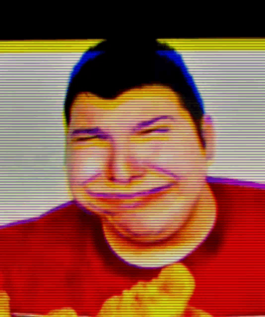 a man in a red shirt is smiling with a yellow background