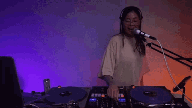a woman is playing a record with the words " and for the record " behind her
