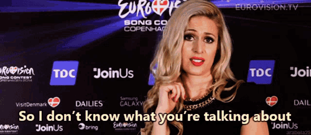 a woman is standing in front of a sign that says eurovision tv