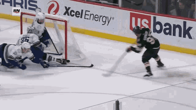 a hockey game is being played in front of a banner for xcel energy