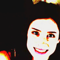 a woman with a bow in her hair smiles for the camera