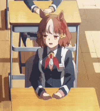 a girl with a horse ear sits at a desk