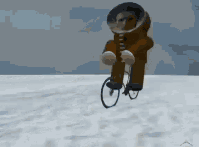 a man in a space suit is riding a bicycle in the air .