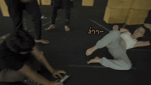 a woman is laying on the floor while a man holds her up in the air