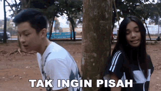 a boy and a girl are standing next to each other with the words tak ingin pisah written on the bottom