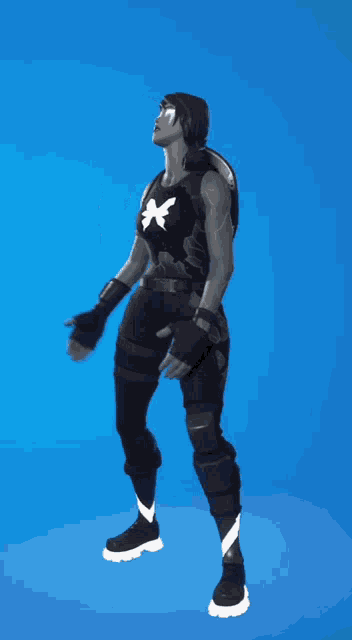 a person in a black and white outfit is standing on a blue background