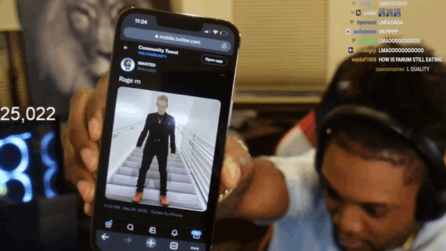 a person holding up a cell phone with a picture of a man on it