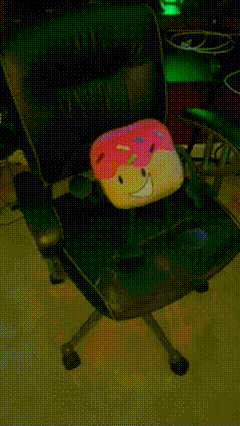 a blurred image of a table with a few items on it including a pink bag