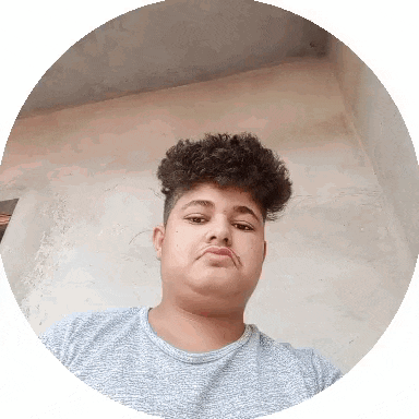 a young man with curly hair looks at the camera in a circle .