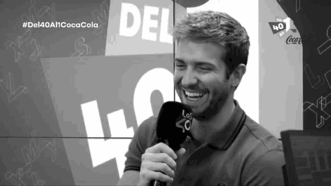 a man is smiling in front of a sign that says del 40