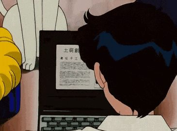 a man is sitting at a desk using a laptop computer while a cat watches .