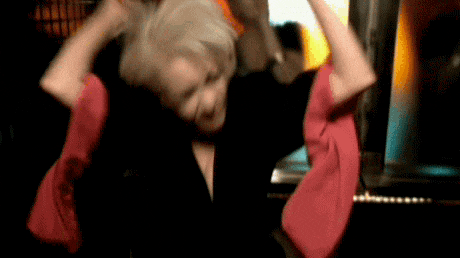 a woman is holding a red towel over her head in a blurry photo .