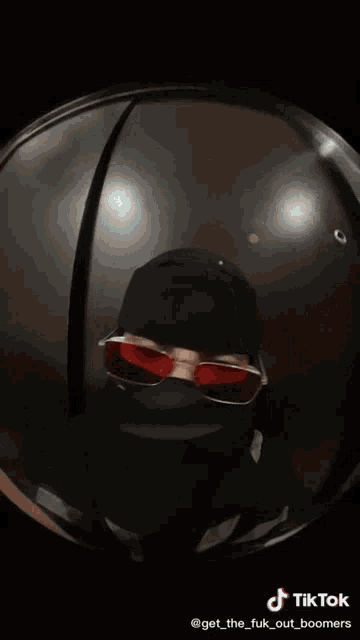 a tiktok video of a person wearing a mask and sunglasses