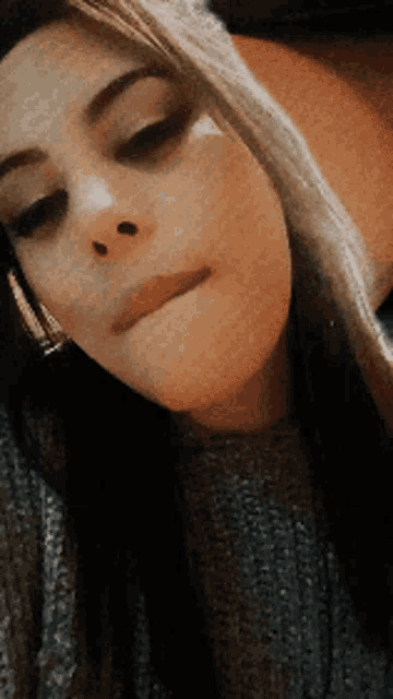a close up of a woman making a face
