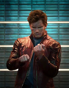 a man wearing a leather jacket is making a fist
