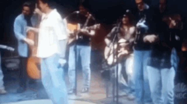 a group of people are playing instruments on a stage