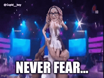 a woman with glasses is being lifted on a man 's shoulders with the words never fear written below her