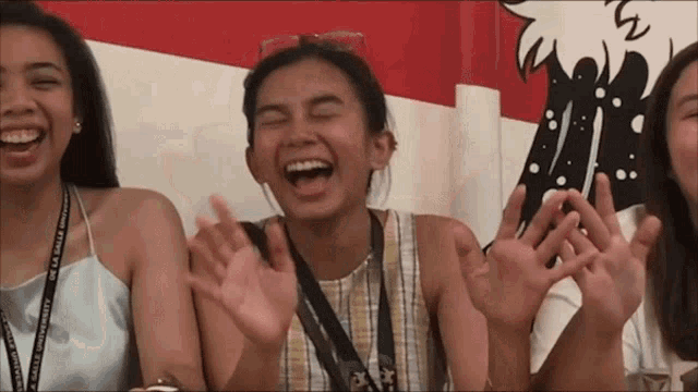a woman wearing a lanyard that says " de la salle " on it