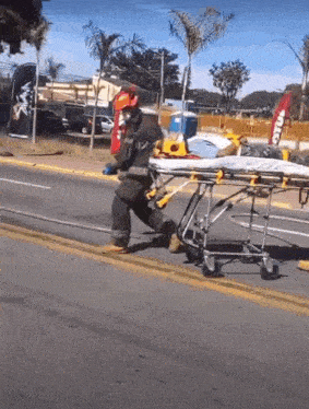 a fireman is carrying a stretcher with a sign that says ' coca cola ' on it