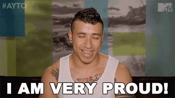 a man with a tattoo on his chest is smiling and says i am very proud