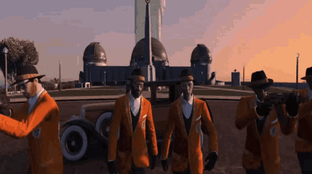 a group of men in orange suits are standing in front of a large building