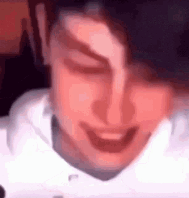 a close up of a person 's face with their eyes closed and smiling .