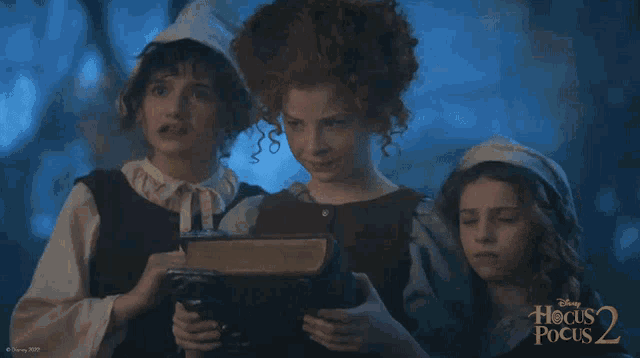 a poster for disney 's hocus pocus 2 showing three girls