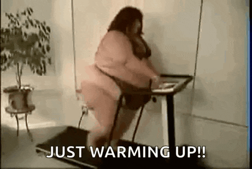 a very fat woman is walking on a treadmill without a shirt on .