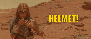 a woman is standing in the desert with the word helmet in yellow letters