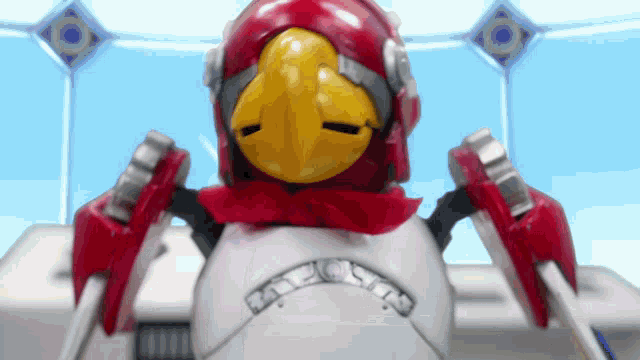 a robot with a red helmet and a yellow beak has the word falcon on it
