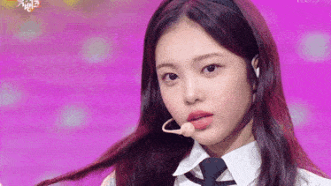 a close up of a girl wearing a headband and a tie .