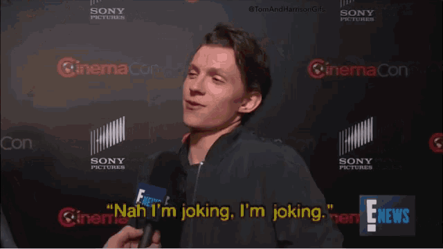 a man is talking into a microphone and says " nah i 'm joking "