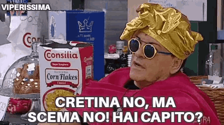 a woman sitting in front of a box of corn flakes says cretina no ma scena no hai capito ?