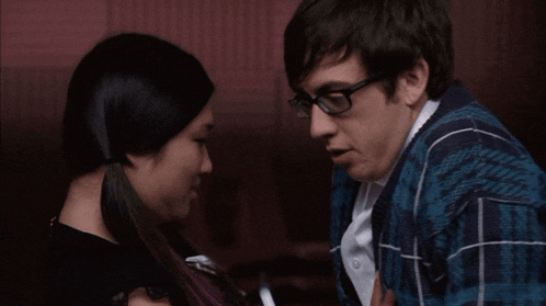 a man and a woman are smiling at each other