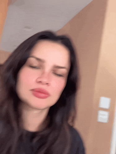 a close up of a woman 's face with a blurry background