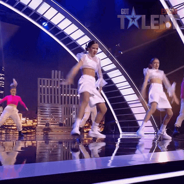 a group of young girls are dancing on a stage with the words got talent written on the bottom