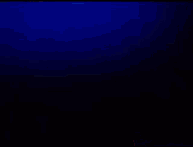 a person is standing in a dark room with a blue light coming out of the ceiling .