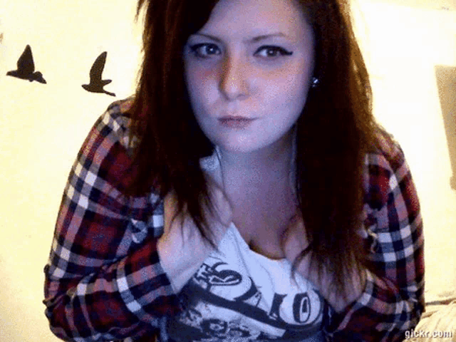 a woman wearing a plaid shirt and a polo shirt