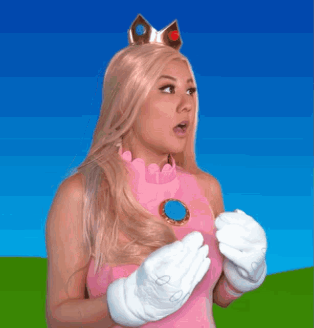 a woman in a princess peach costume with gloves