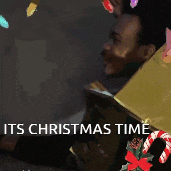 a man is holding a box with the words " it 's christmas time " written on it