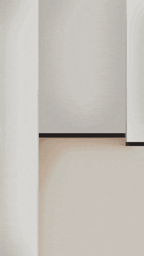 a girl with green nails is peeking out from behind a white wall