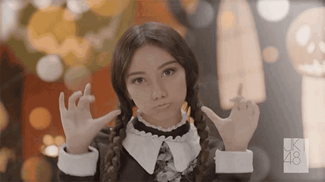 a girl in a halloween costume with the number 48 on her sleeve