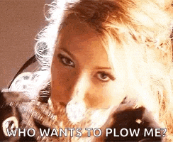 a close up of a woman 's face with the words `` who wants to plow me '' .