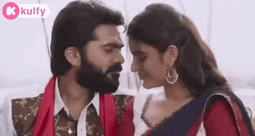 a man and a woman are kissing each other in a movie .
