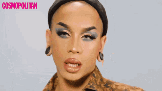 a close up of a woman 's face with a cosmopolitan logo in the corner