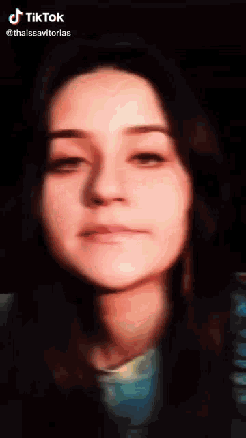 a close up of a woman 's face with the hashtag tiktok at the bottom