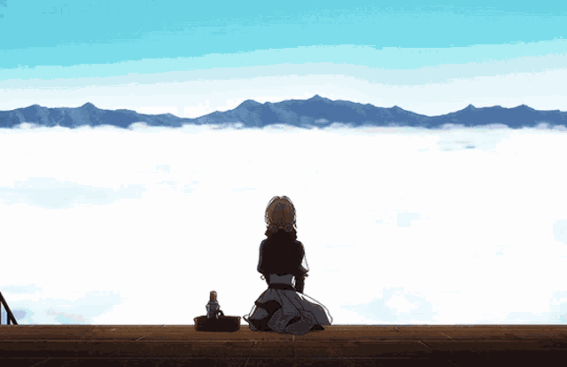 a woman sits on a balcony overlooking a cloudy mountain range