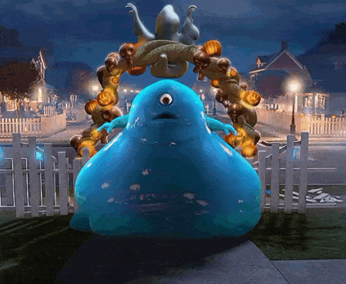 a blue monster with one eye is standing in front of a halloween wreath