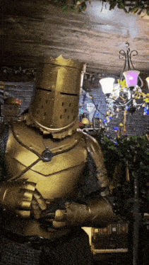 a knight in gold armor with a crown on his helmet